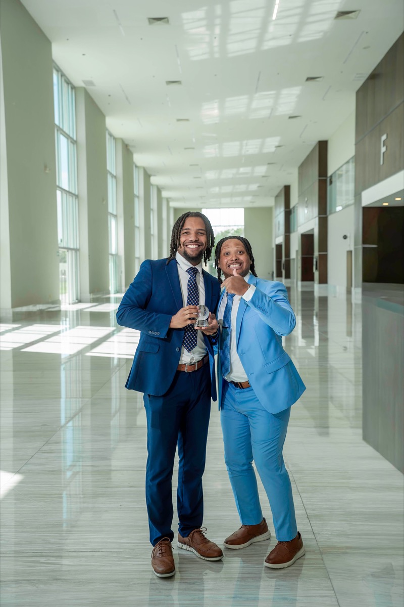 Gritology Inc team members celebrating a brand performance award